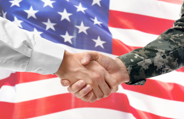 handshake in front of american flag - How to Use Your GI Bill® to Advance Your Civilian Career