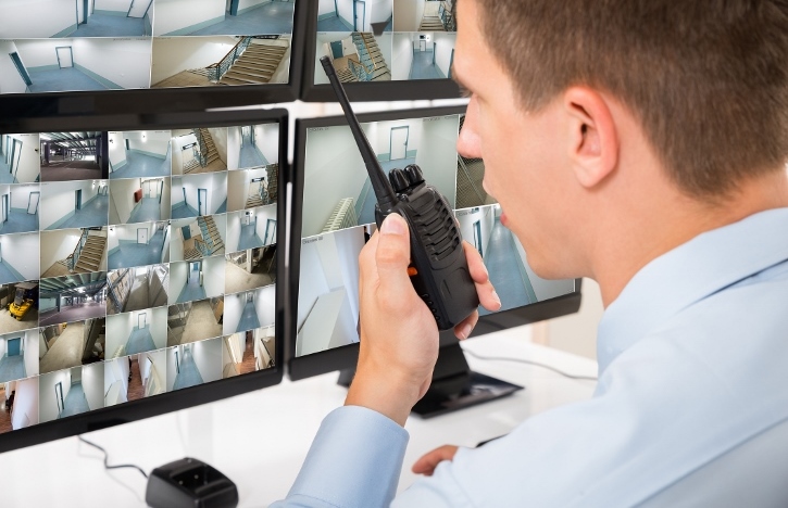 security guard speaking on walkie-talkie after completing Security Guard Training at PWA.edu