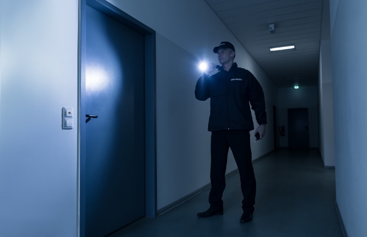 security guard in searching a hallway carrying his california guard card